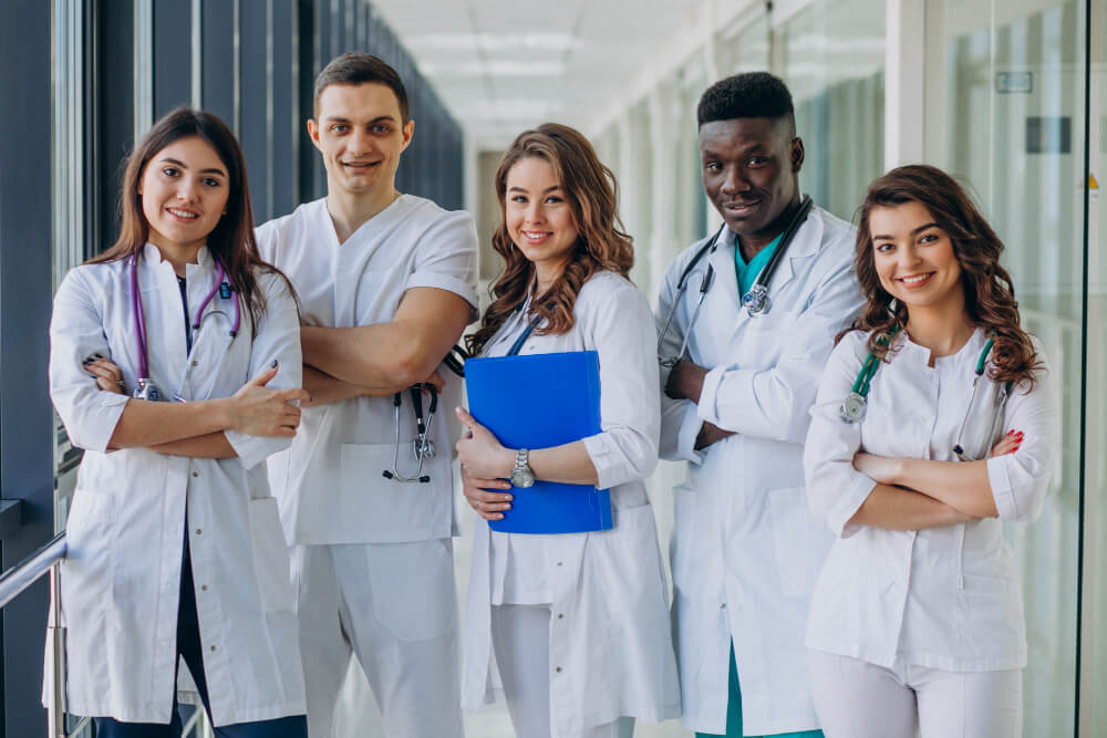 Nephrology USCE An image highlighting the Nephrology U.S. Clinical Experience (USCE) opportunities, showcasing a team of young specialist doctors standing in a hospital corridor.